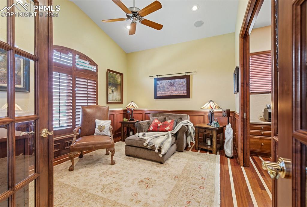 Image 27 of 50: note the cherry and maple floors and library paneling. Pocket doors to the 