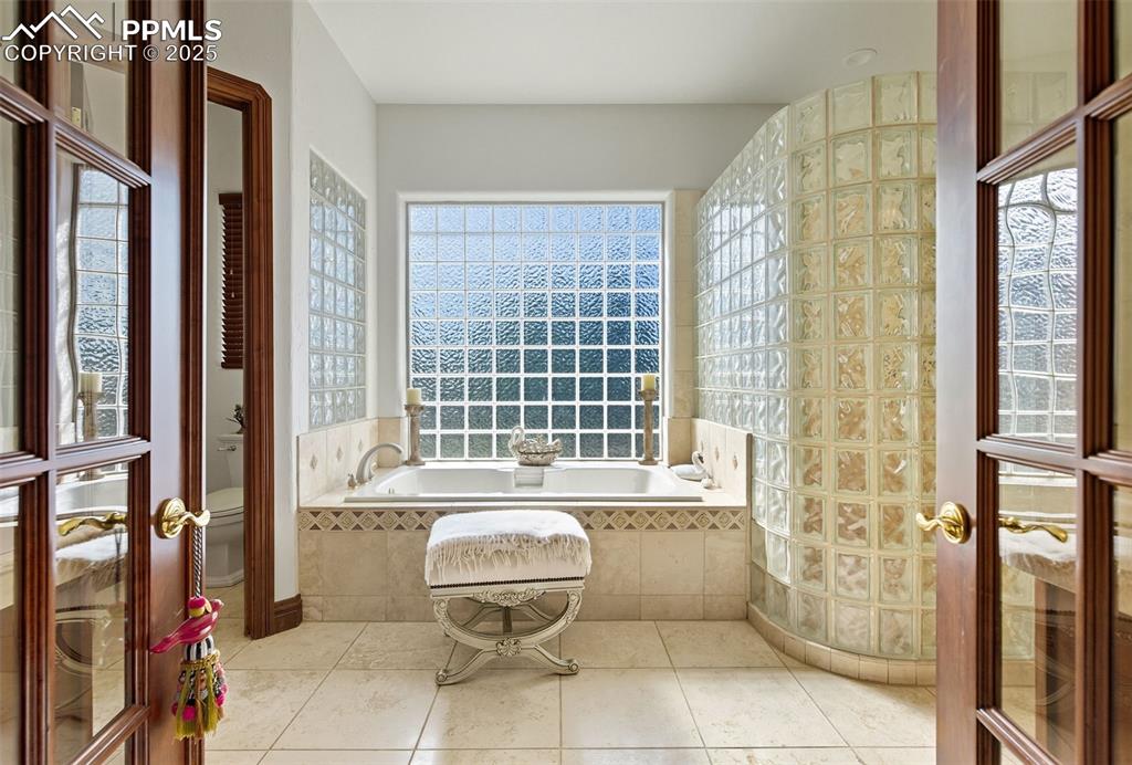Image 34 of 50: the large primary bath has a walk-in shower with 4 body sprays. The 6