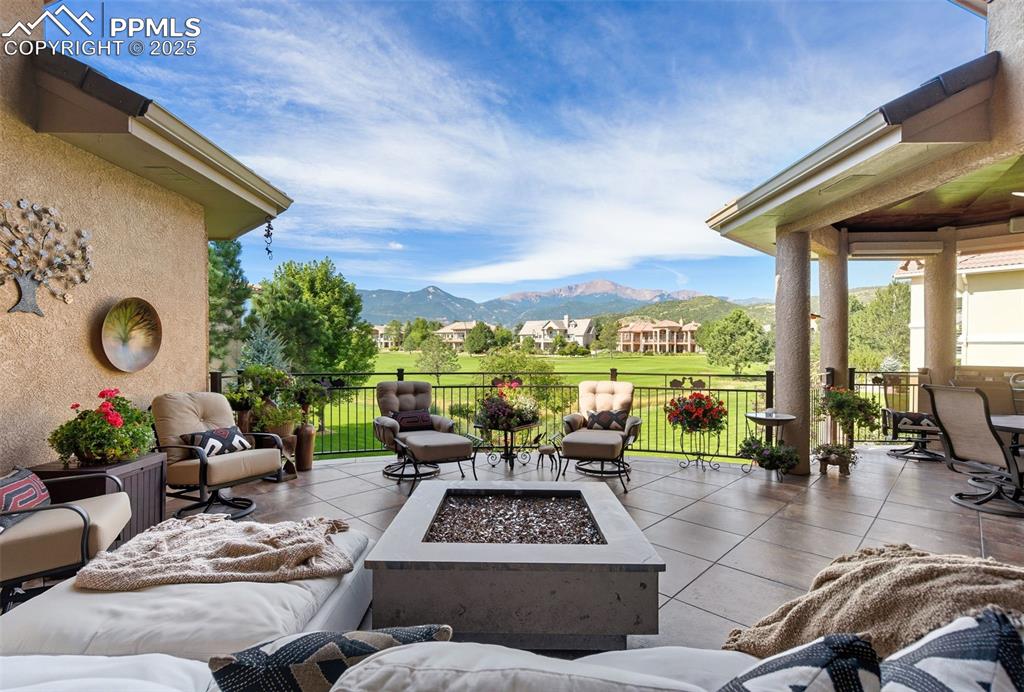 Image 45 of 50: The large rear patio has unsurpassed mountain views, a custom firepit and a