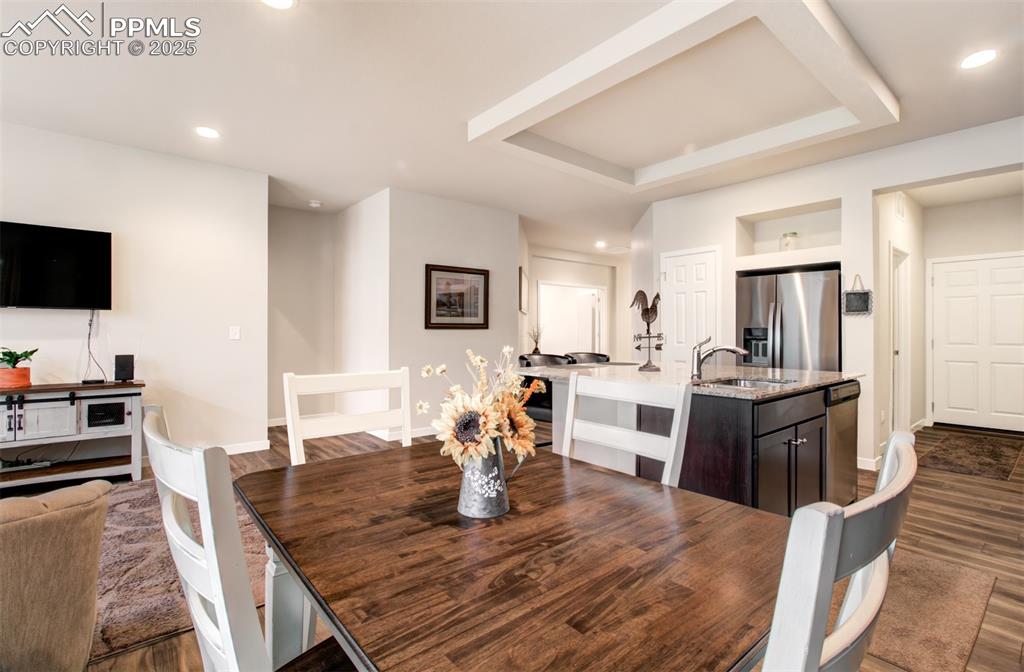 Image 17 of 39: Dining room featuring dark wood-type flooring, baseboards, recessed lightin
