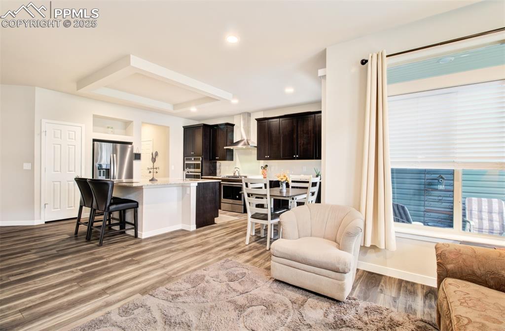 Image 19 of 39: Kitchen featuring appliances with stainless steel finishes, wall chimney ex