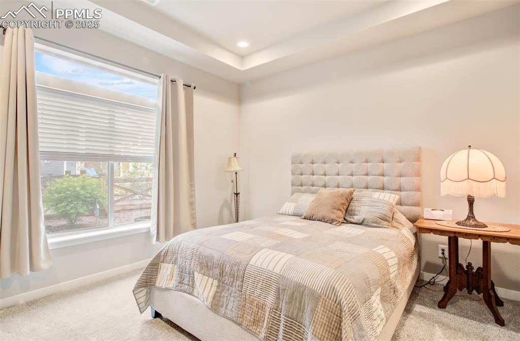 Image 20 of 39: Carpeted bedroom