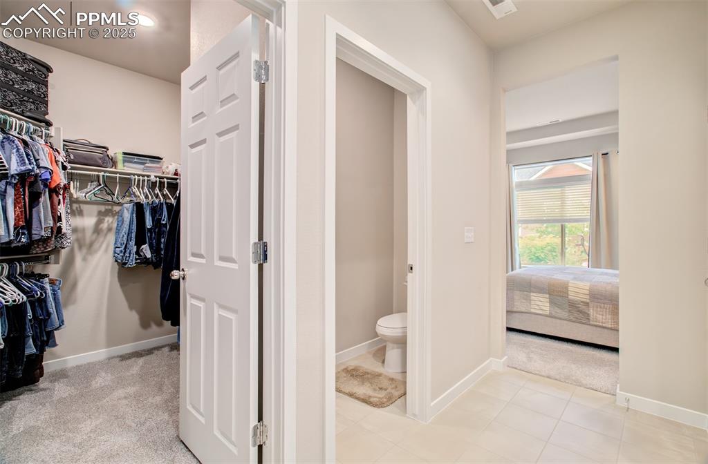Image 22 of 39: Ensuite bathroom with double vanities, Shower and walk in closet.