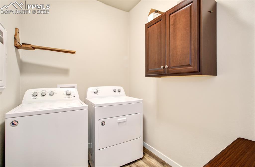 Image 23 of 39: Laundry room with cabinet. Washer and Dryer are Included.