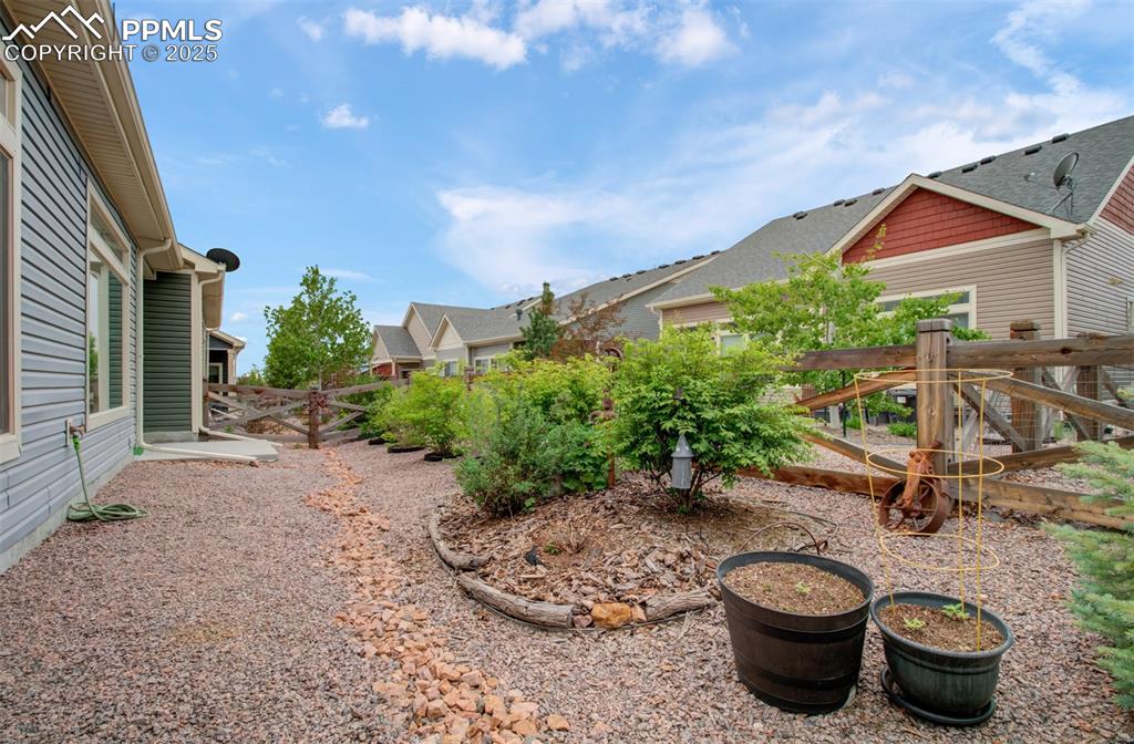 Image 28 of 39: Backyard has a drip line to all the shrubs.