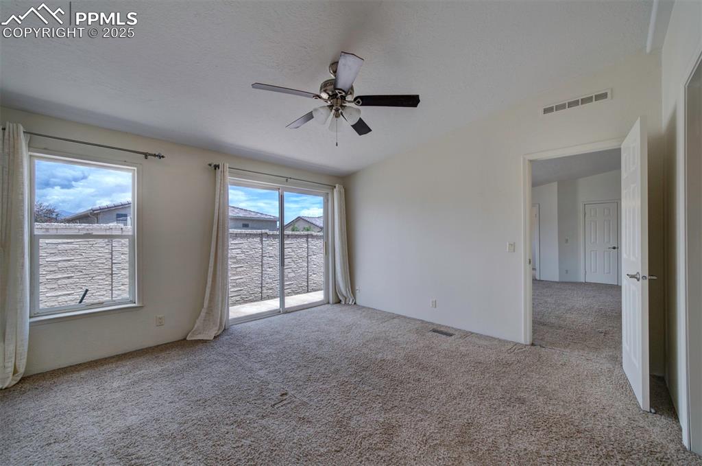 Image 16 of 31: Unfurnished room with carpet and a ceiling fan