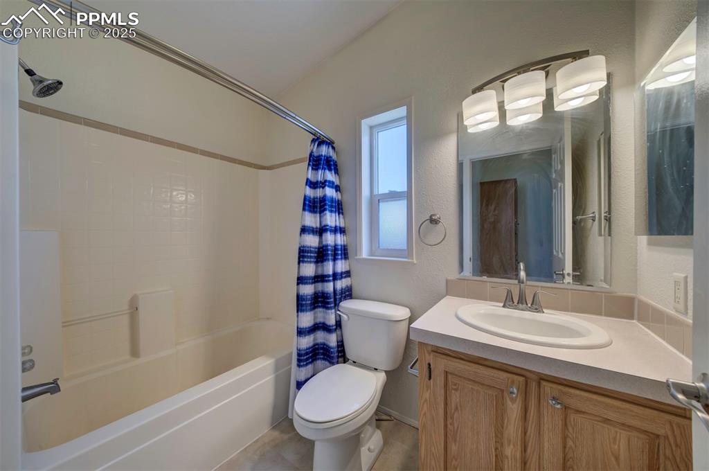Image 20 of 31: Full bath with shower / bathtub combination with curtain and vanity