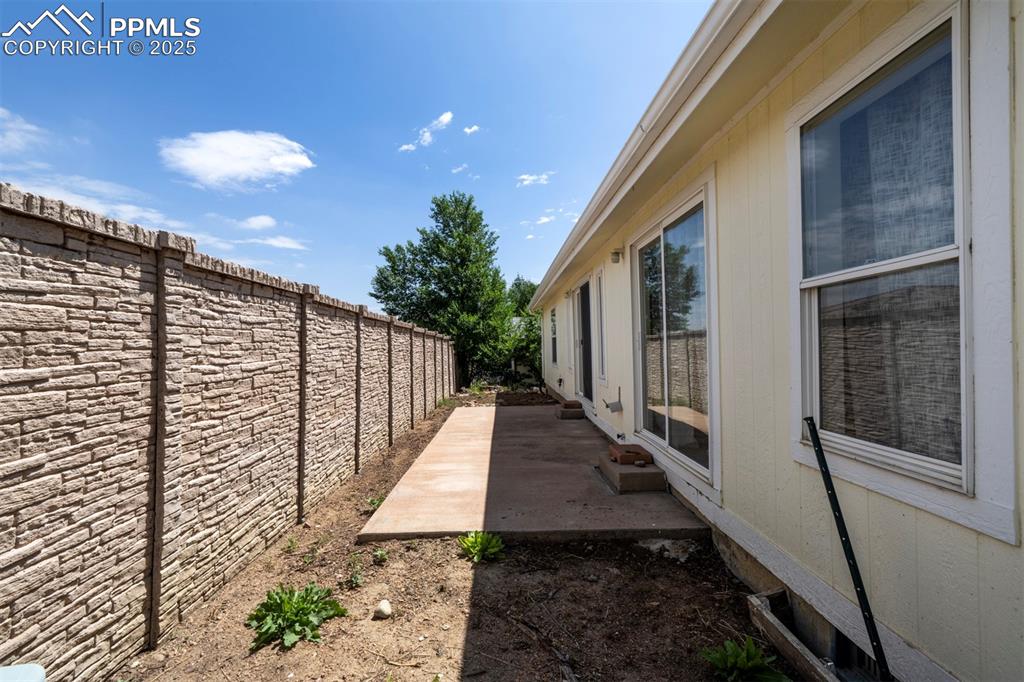 Image 24 of 31: Fenced backyard featuring a patio area