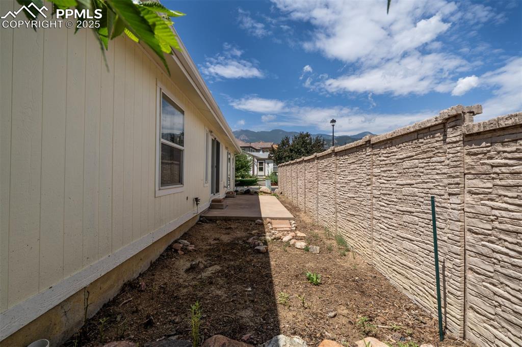 Image 25 of 31: View of yard featuring a mountain view and a patio area