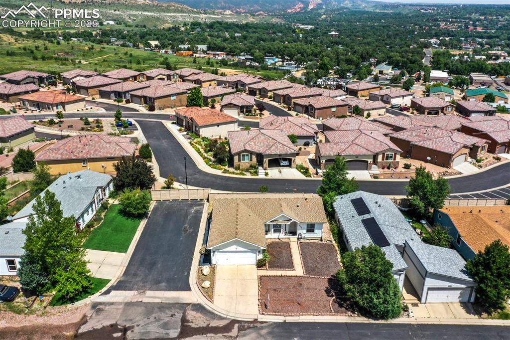 Image 26 of 31: Aerial view of residential area featuring a mountain backdrop