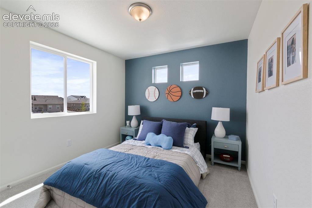 Image 16 of 20: Carpeted bedroom featuring a large window, recessed wall niches, and a ceil