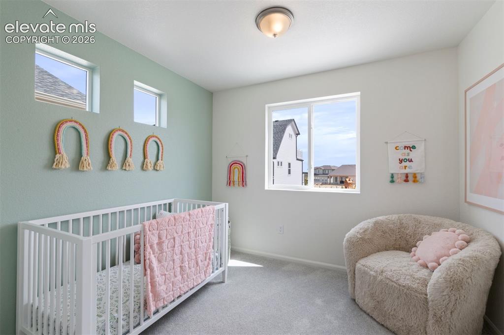 Image 17 of 20: Bright room featuring a large picture window, two high transom windows, lig