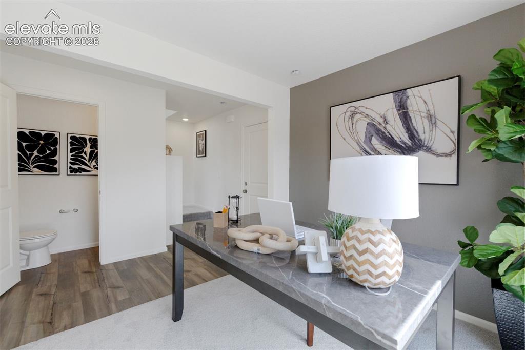 Image 2 of 20: Versatile interior space featuring wood-finish flooring and a neutral color