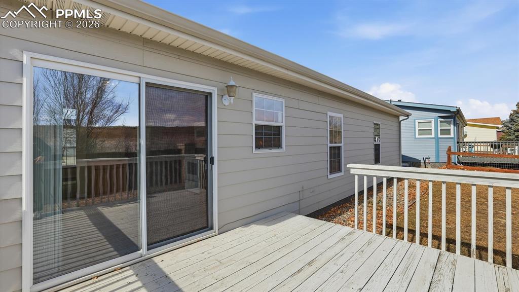 Image 12 of 37: Backyard Deck into the Dining Area.