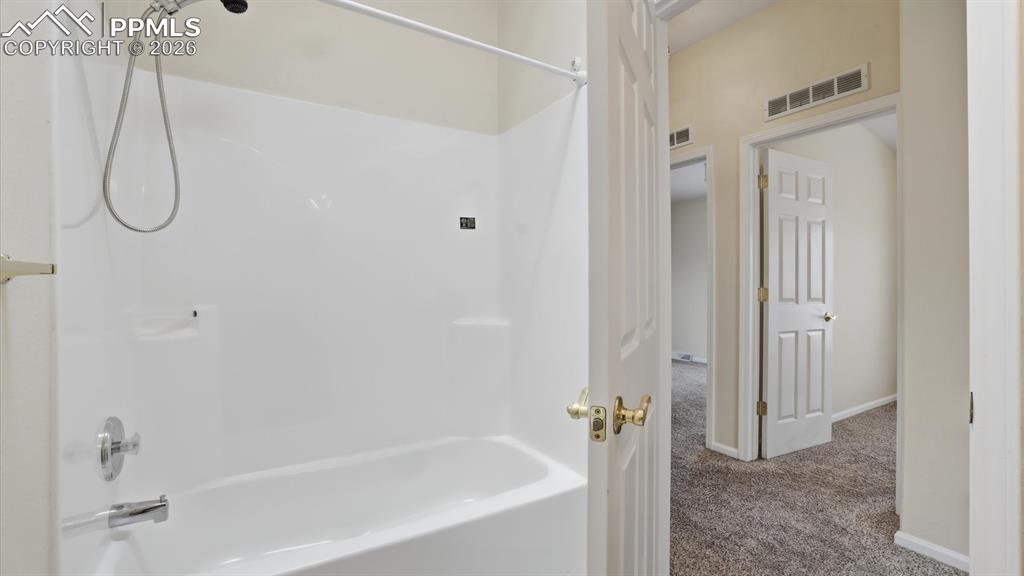 Image 19 of 37: Tub/shower in the Full Bathroom.