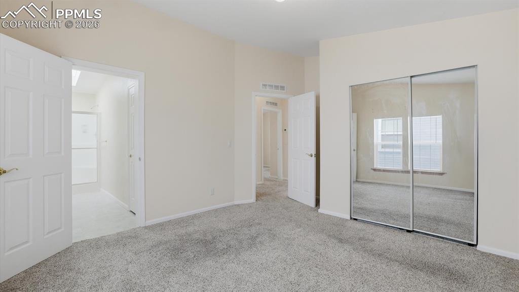 Image 22 of 37: The Primary Bedroom featured a mirrored wardrobe closet and adjoining Showe