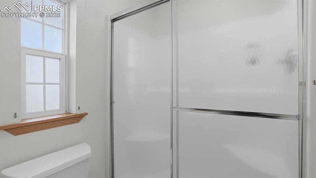 Image 24 of 37: The Primary Bathroom has an enclosed shower with built-in seating.