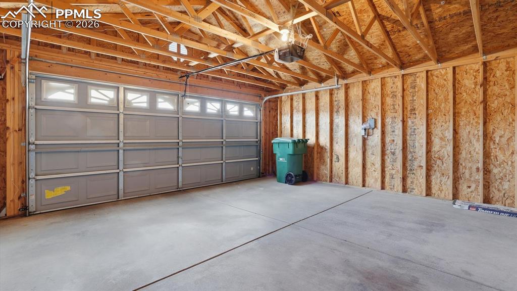Image 30 of 37: Two car attached garage with door opener.