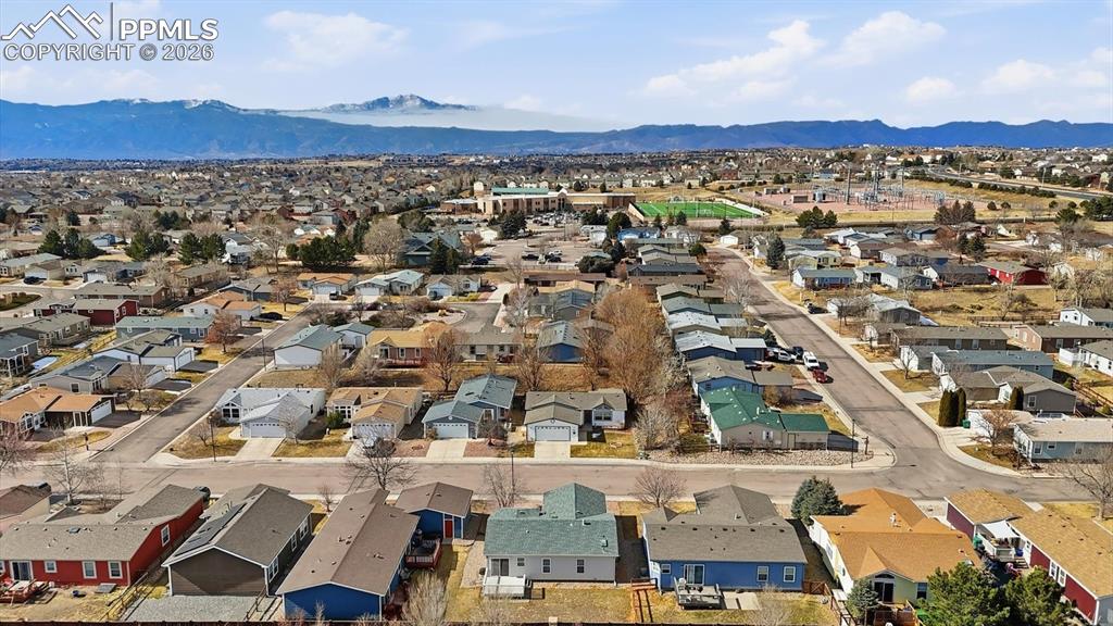 Image 35 of 37: Aerial view of home, neighborhood, and mountains.