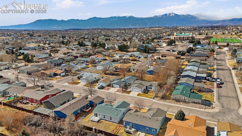 Image 36 of 37: Aerial view of home, neighborhood, and mountains.