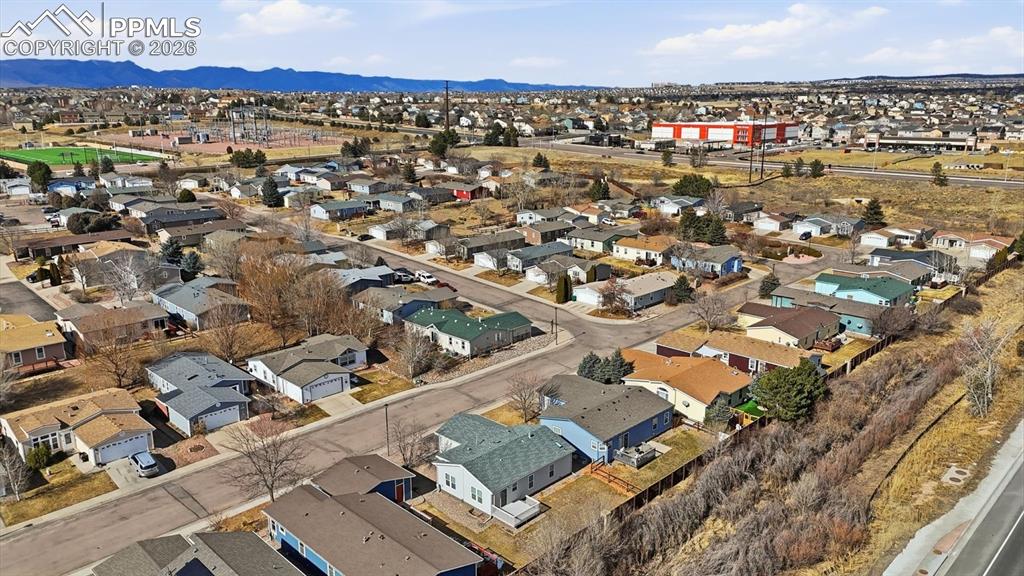 Image 37 of 37: Aerial view of home and fenced yard that backs to open space.