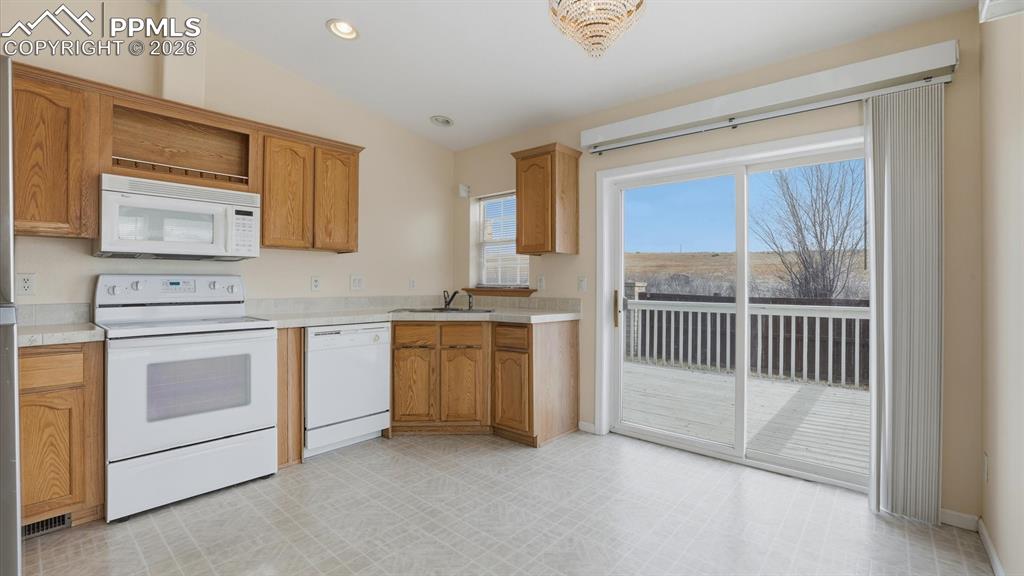 Image 8 of 37: Eat-In Kitchen, complete with durable vinyl flooring, ample wood cabinetry,
