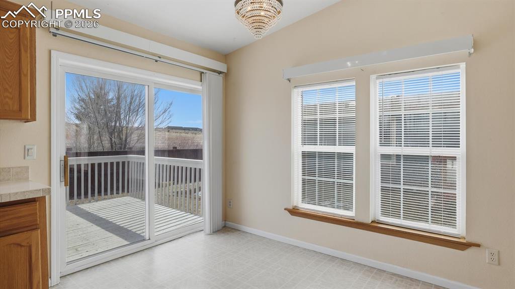 Image 9 of 37: Dining Area with walk out to the backyard deck.