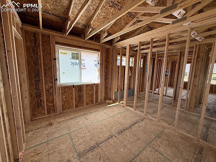 Image 16 of 20: Bedroom 2 located on the upper level. Please, excuse our dust as this home