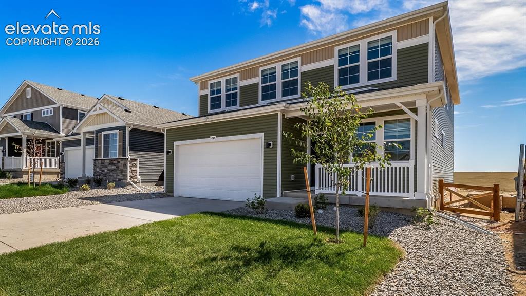 Image 1 of 40: Two-story residence featuring a two-car garage, front porch, and a combinat