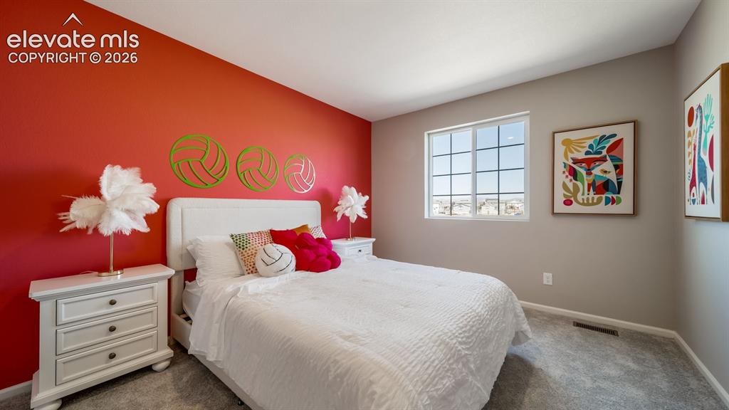 Image 11 of 39: Bedroom featuring a prominent accent wall and a large window
Photos of a m