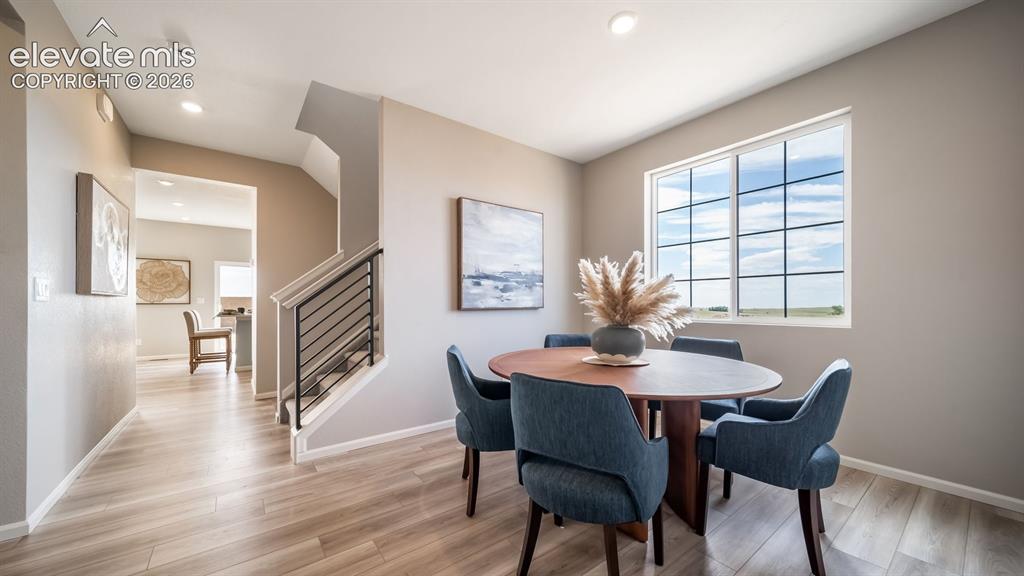 Image 13 of 39: Dining area featuring a large window, recessed lighting, and wood-finish fl