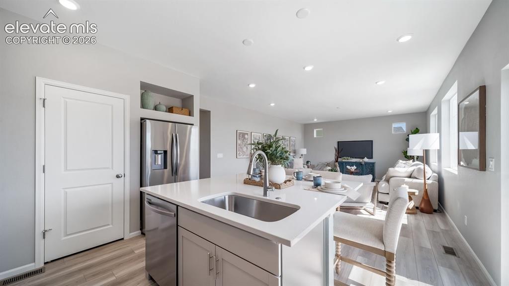 Image 21 of 39: Kitchen island with an undermount sink and a matte black faucet
Photos of