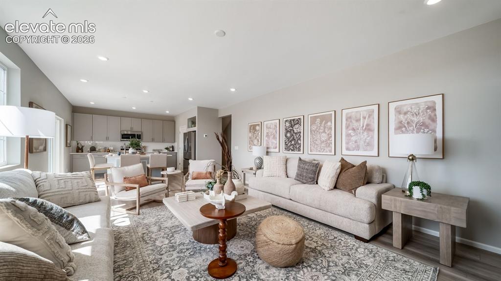 Image 27 of 39: Open-concept living area featuring recessed lighting and wood-finish floori