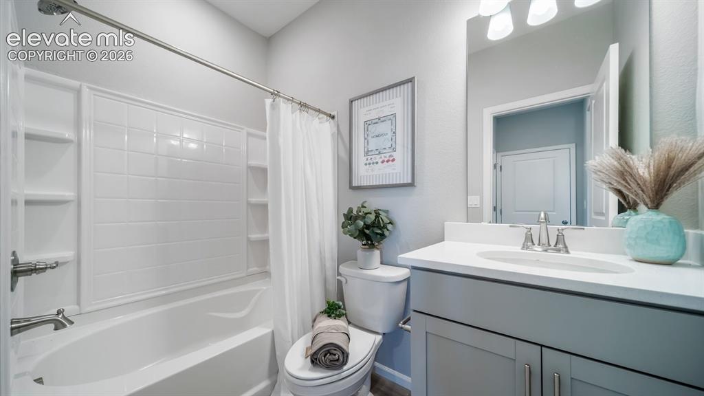 Image 3 of 39: Bathroom featuring a built-in tub and shower combination with integrated sh