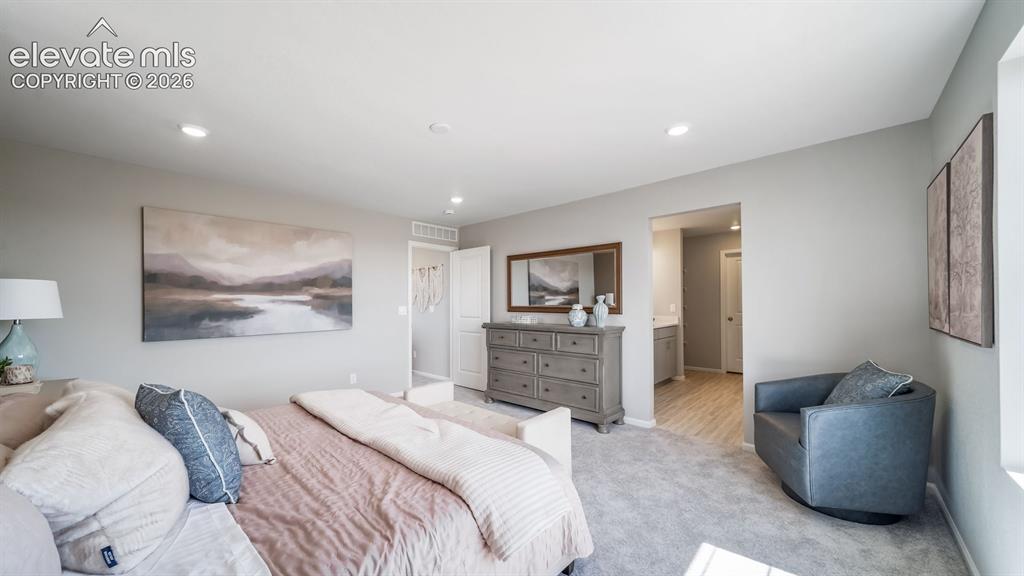 Image 33 of 39: Spacious room featuring neutral wall tones, recessed lighting, and soft gra