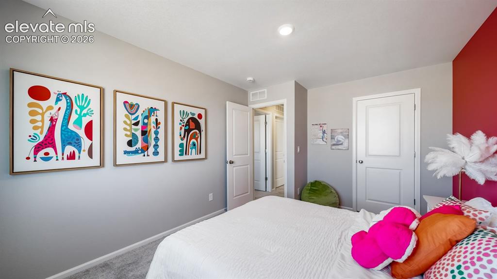 Image 5 of 39: Bedroom featuring a recessed ceiling light, an interior door with a paneled