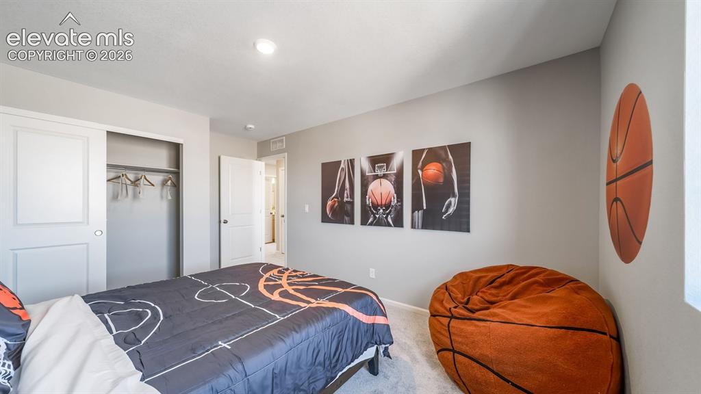 Image 7 of 39: Bedroom featuring light gray wall paint, light-colored carpet flooring, a w