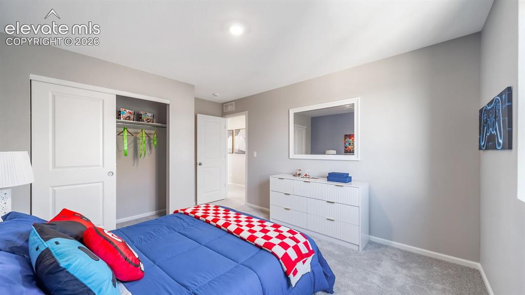 Image 9 of 39: Bedroom featuring light gray wall paint and gray carpeting
Photos of a mod