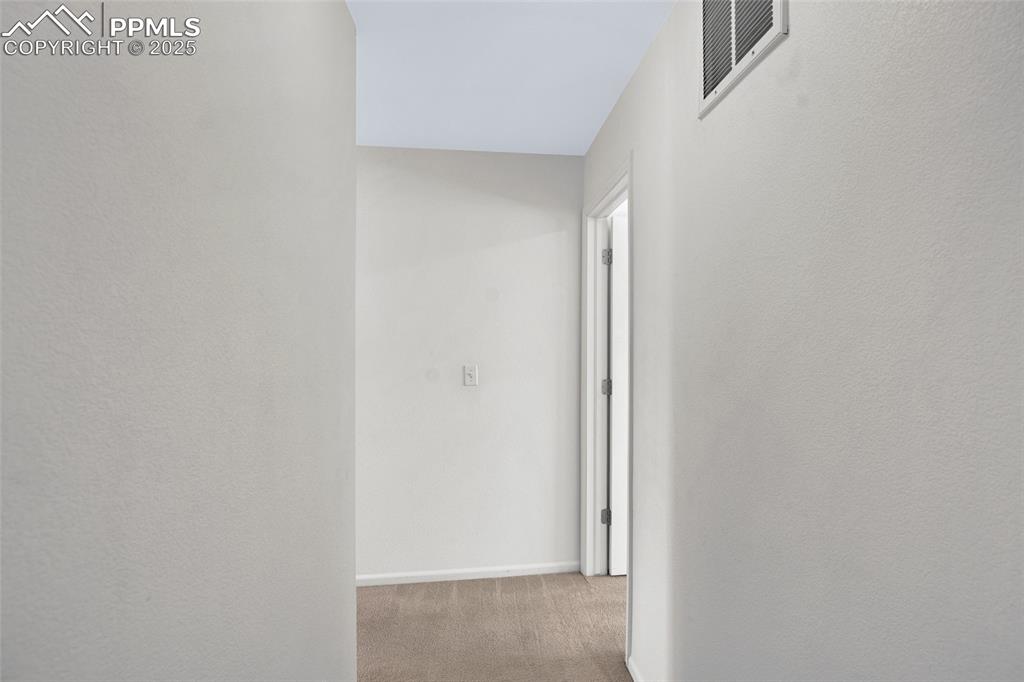 Image 12 of 24: Hall with carpet flooring and baseboards