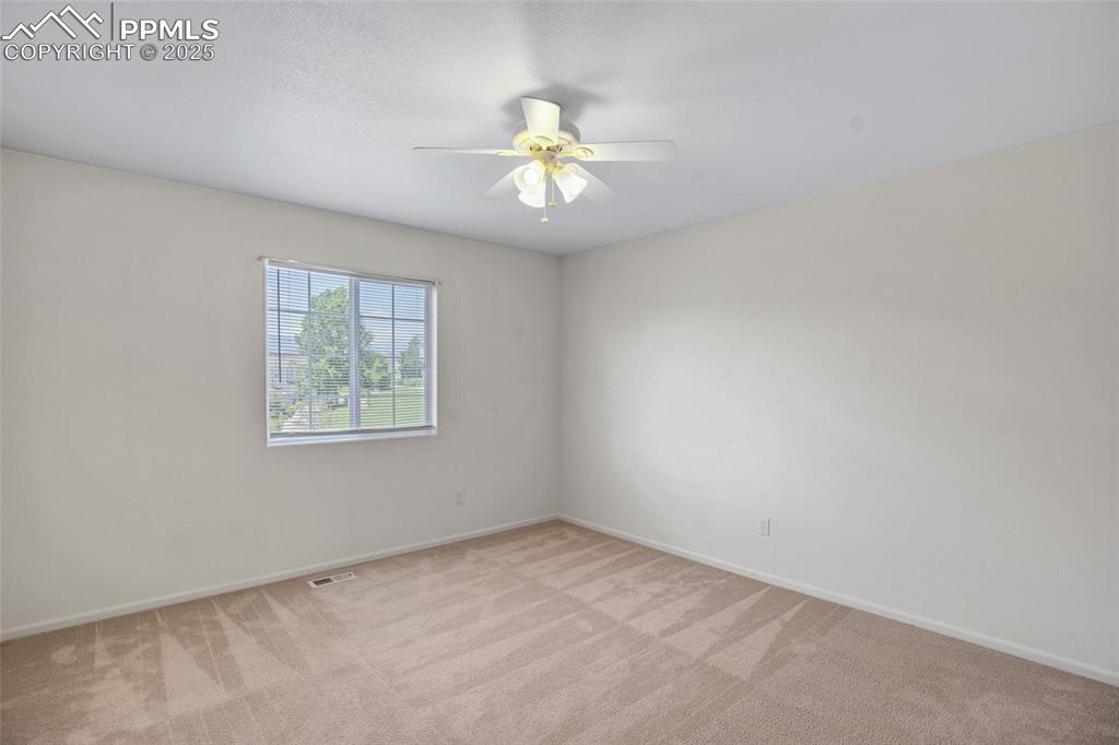 Image 14 of 24: Unfurnished room with light carpet and a ceiling fan
