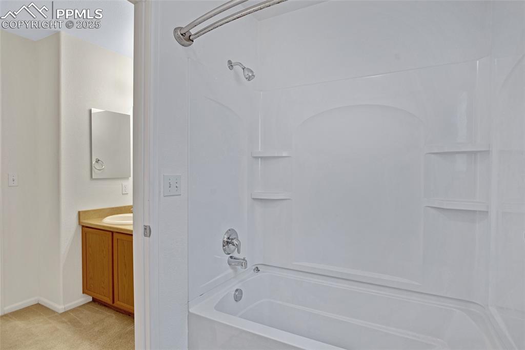 Image 19 of 24: Full bathroom with shower / bath combination and vanity