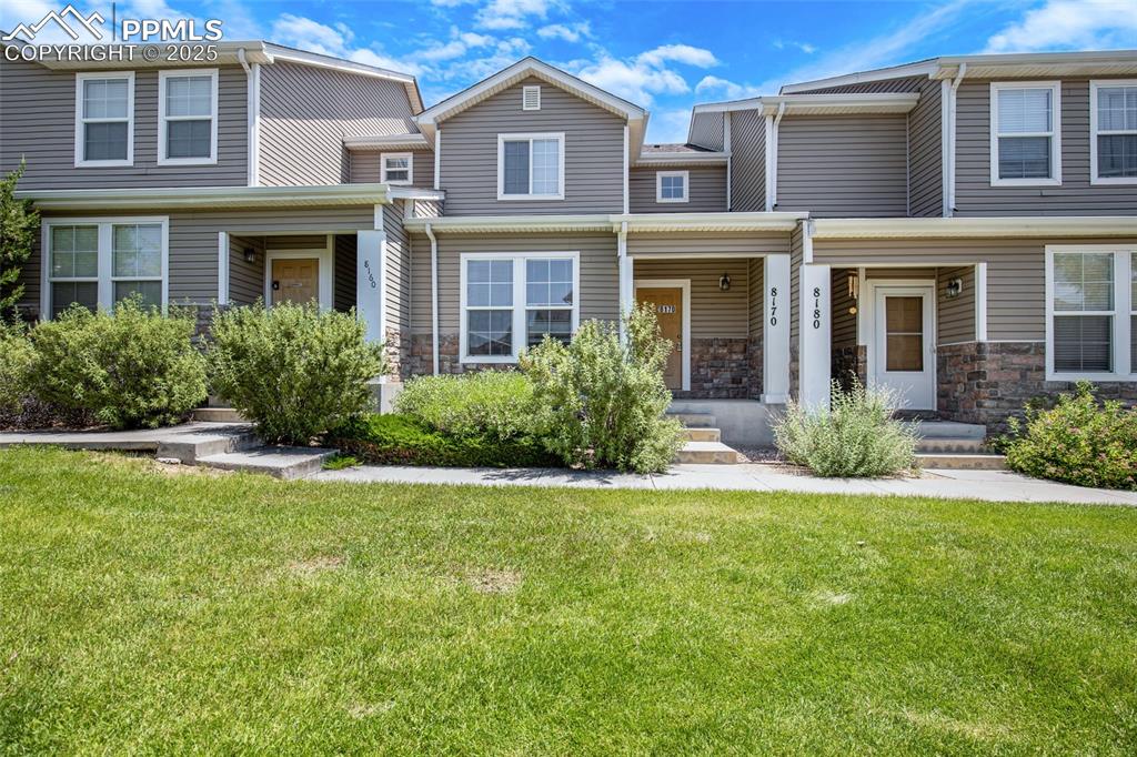 Image 2 of 24: View of property featuring stone siding and a front yard
