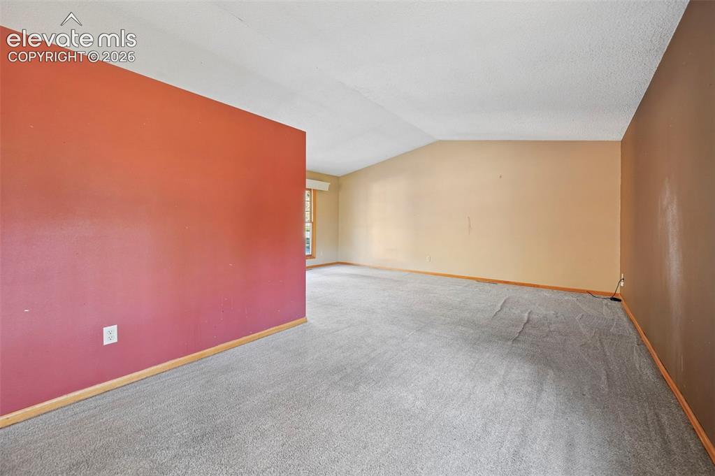 Image 19 of 47: Wall-to-wall carpeting and sloped ceiling