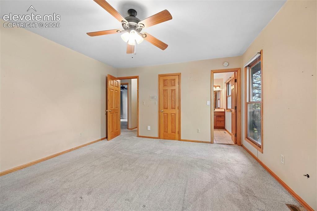 Image 25 of 47: Carpeted room featuring a ceiling fan with integrated lighting, wood-finish