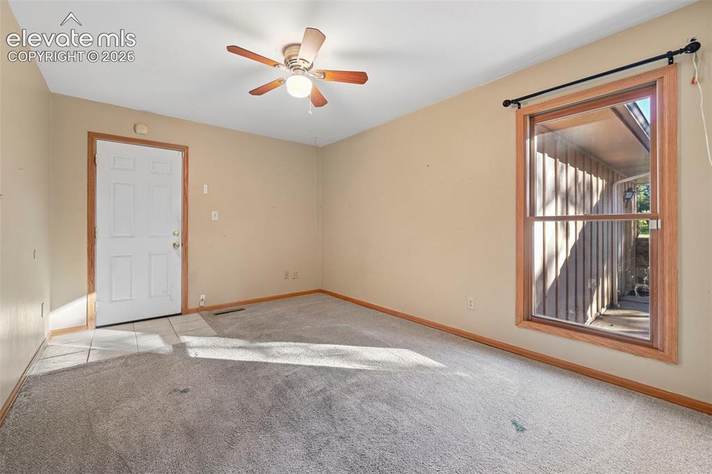 Image 29 of 47: Ceiling fan with integrated lighting, wood-trim window, and tiled entry