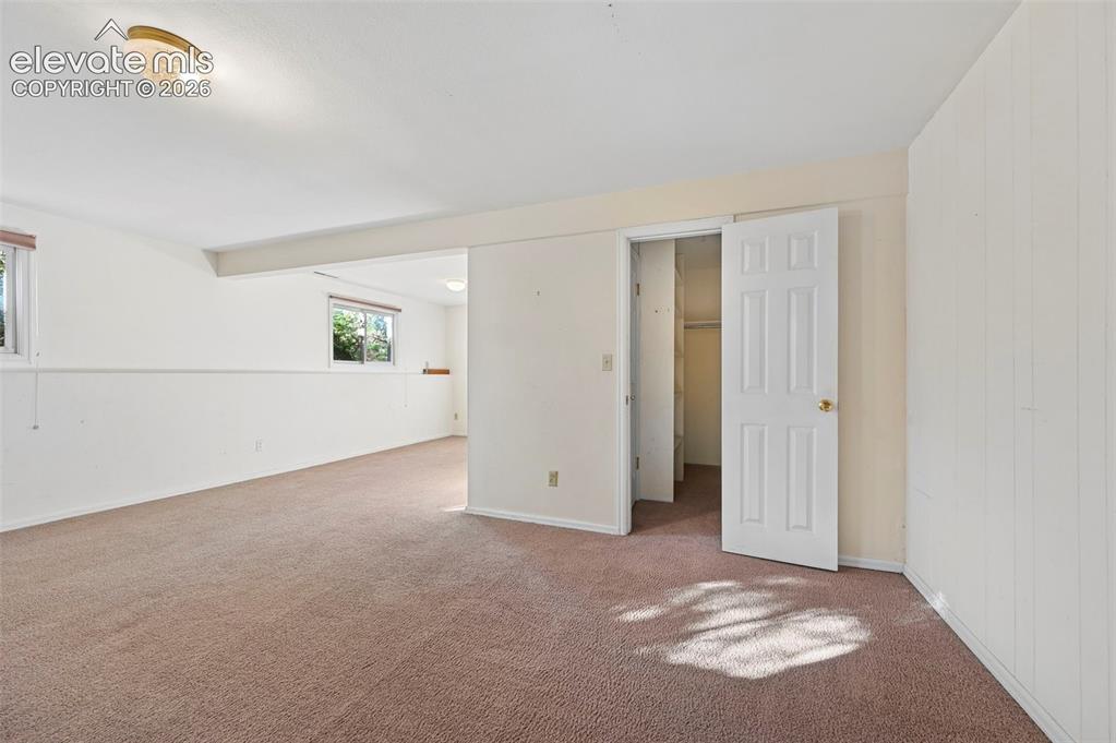 Image 42 of 47: Carpeted interior space with white walls, multiple windows, and a flush mou