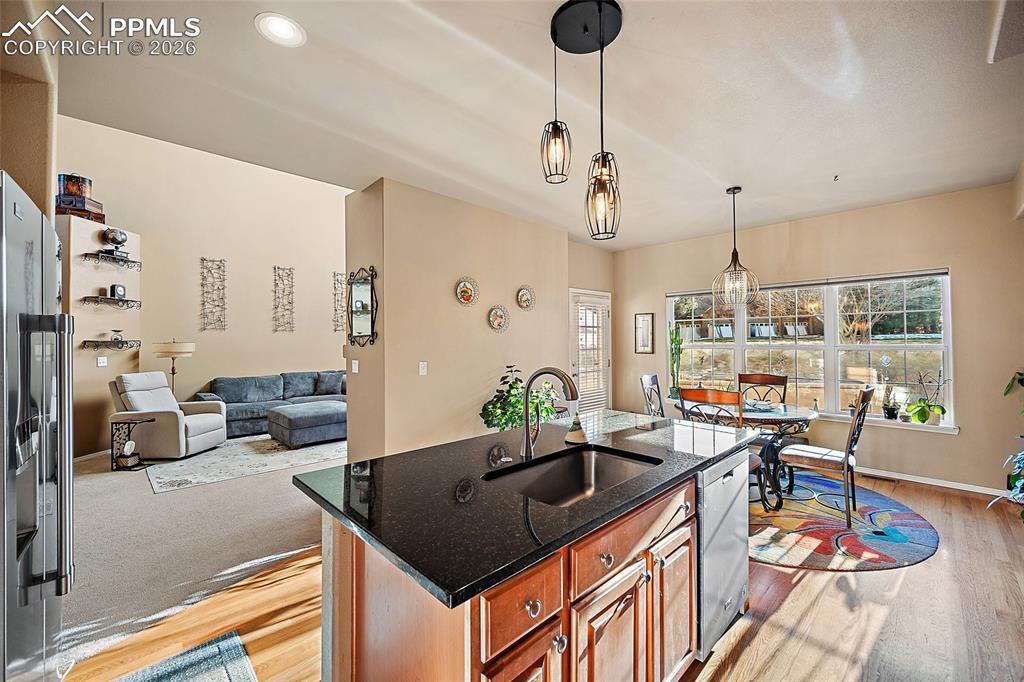 Image 12 of 49: Wood flooring and opens to the living room. 