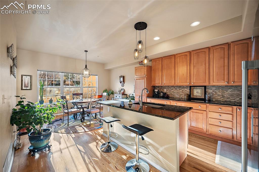 Image 12 of 50: Open kitchen that walk out to the patio. Granite countertops and gorgeous b
