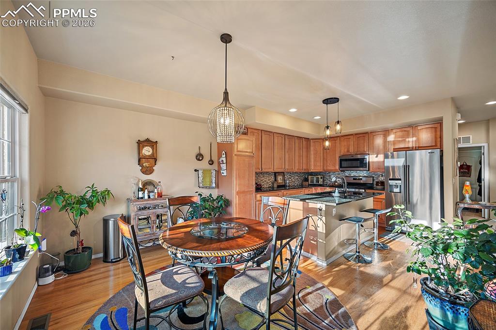 Image 13 of 49: kitchen and dining room combo makes entertaining easy. 