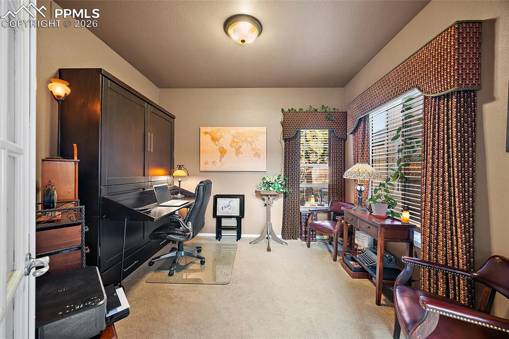 Image 18 of 50: Private office right off of the front door. Murphy bed conveys with the sal